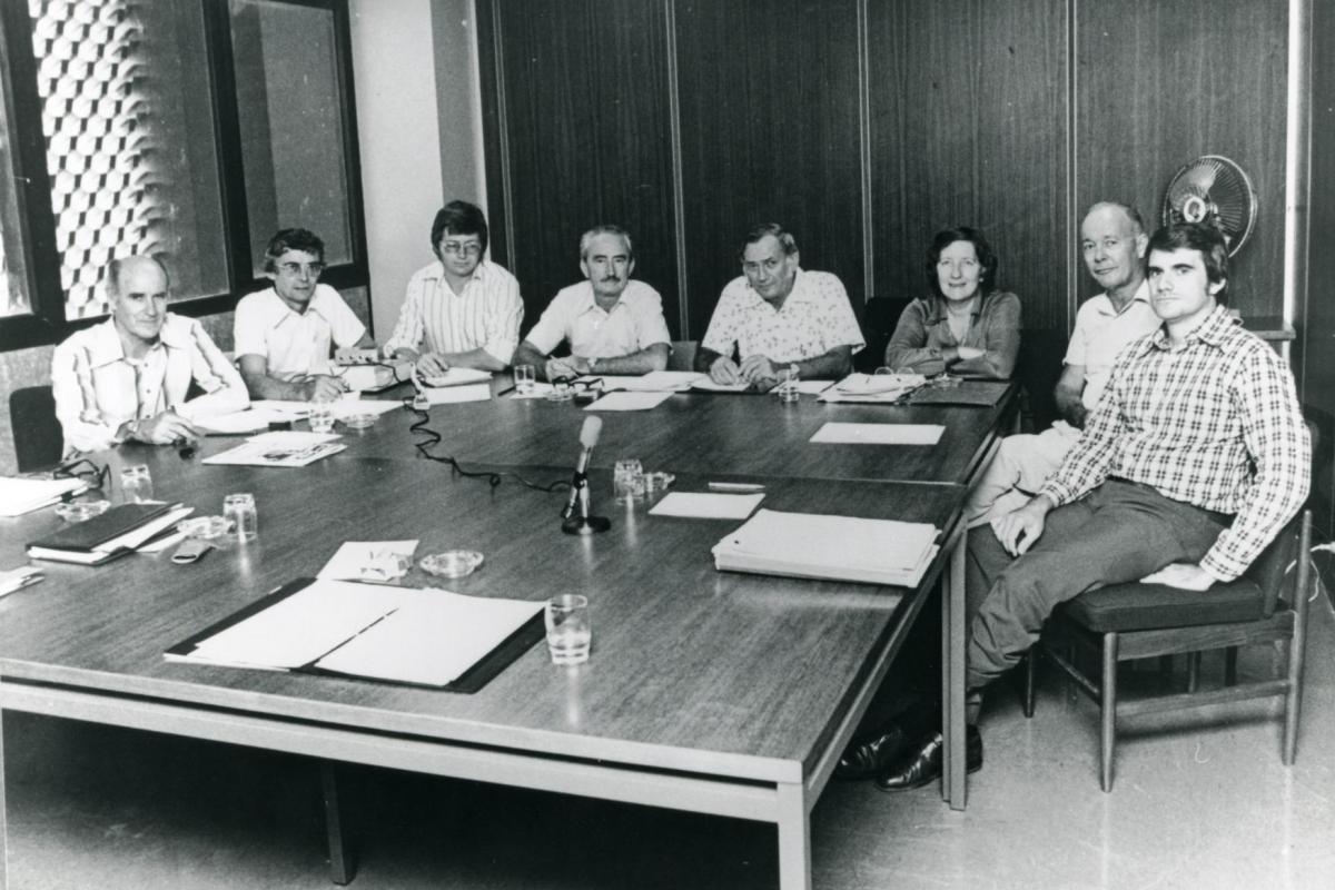 Meeting of Darwin Reconstruction Committee. L-R: Ron Thomas (Construction); Ian Morrison (Housing and Construction Department); Phil Spring; Frank Dwyer (Acting Chairman); John Parsons (General Manager); Dr Ella Stack (Darwin City Council); Vern O'Brien (Dept. of Northern Territory); Grant Tambling (Legislative Assembly).
