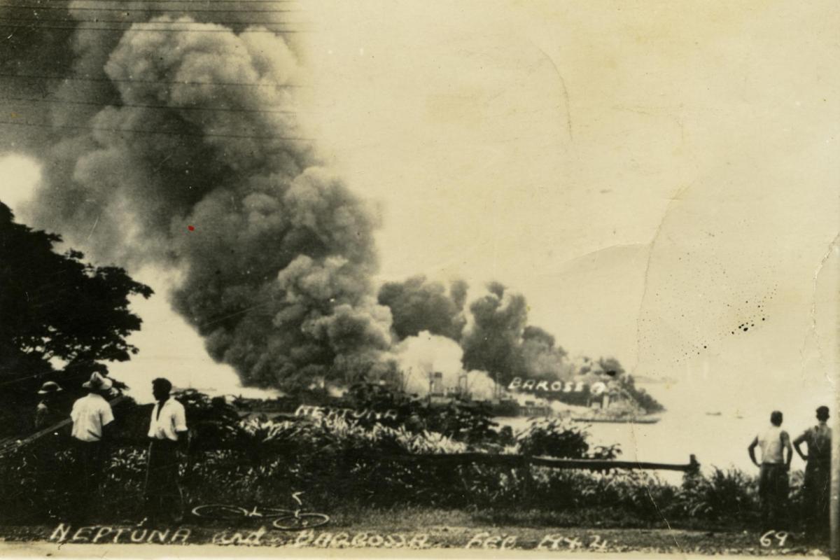Onlookers observe burning ships in Darwin Harbour after the first Japanese bombing raid in February 1942.