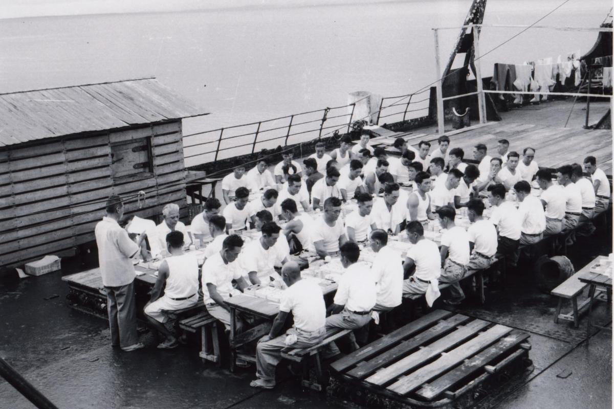 Employees of the Fujita Salvage Company celebrate a New Year’s Day lunch on board the MV British Motorist in 1961.