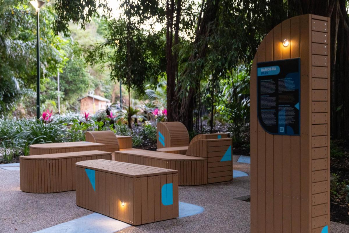 Photograph of revitalised Damoe-ra Park with geometric style wooden block seating with turquoise accents.
