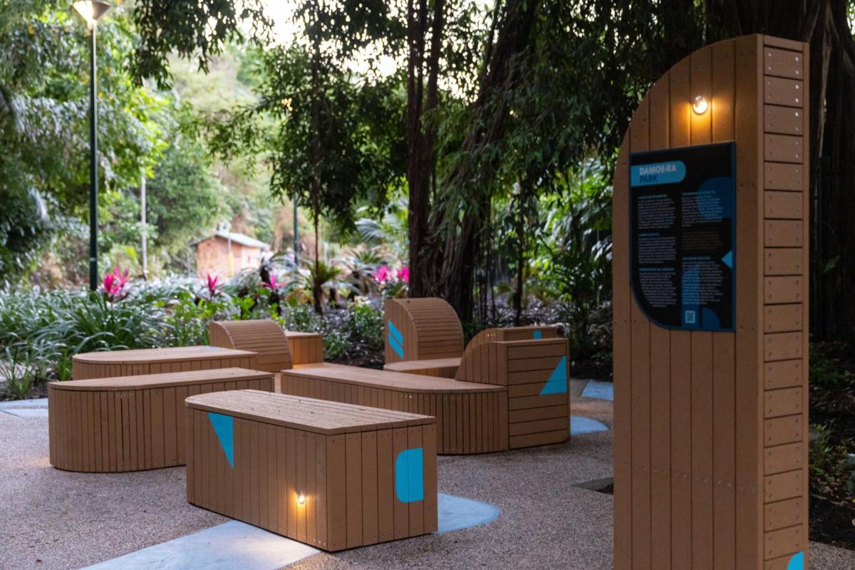 Photograph of revitalised Damoe-ra Park with geometric style wooden block seating with turquoise accents.