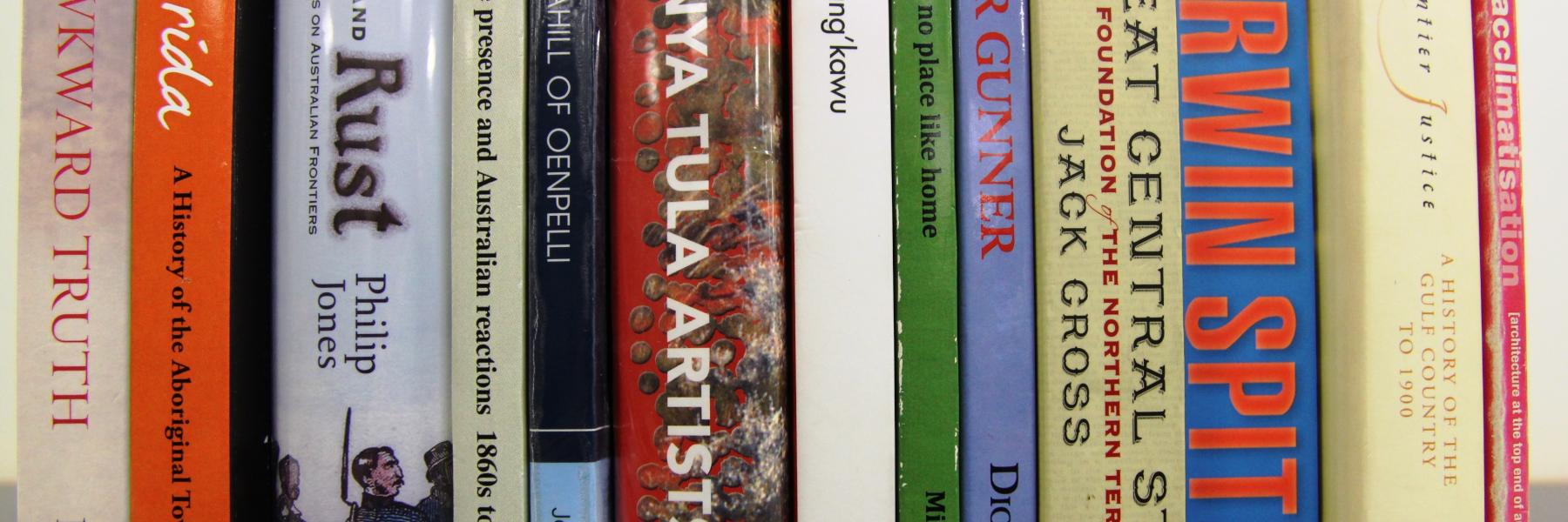 Photo of the book spines of past winners of the Chiref Minister's Northern Territory History Book Award