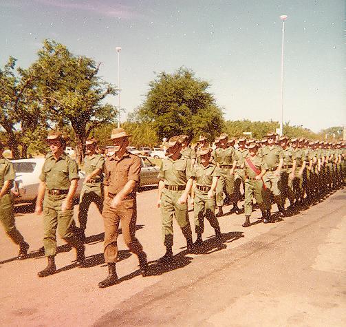 Soldiers outside marching in a line.