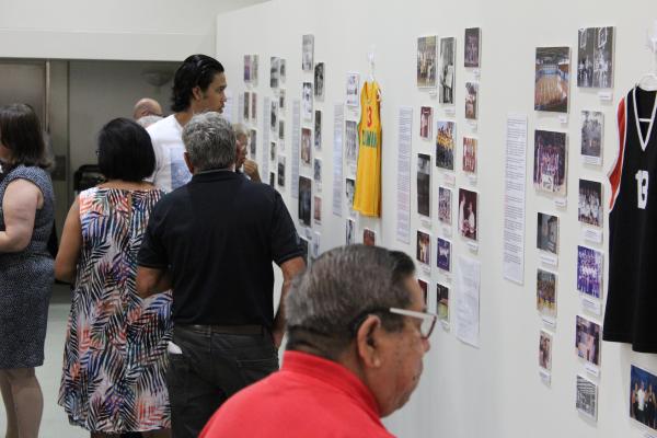 Crowd of people looking at exhibition wall