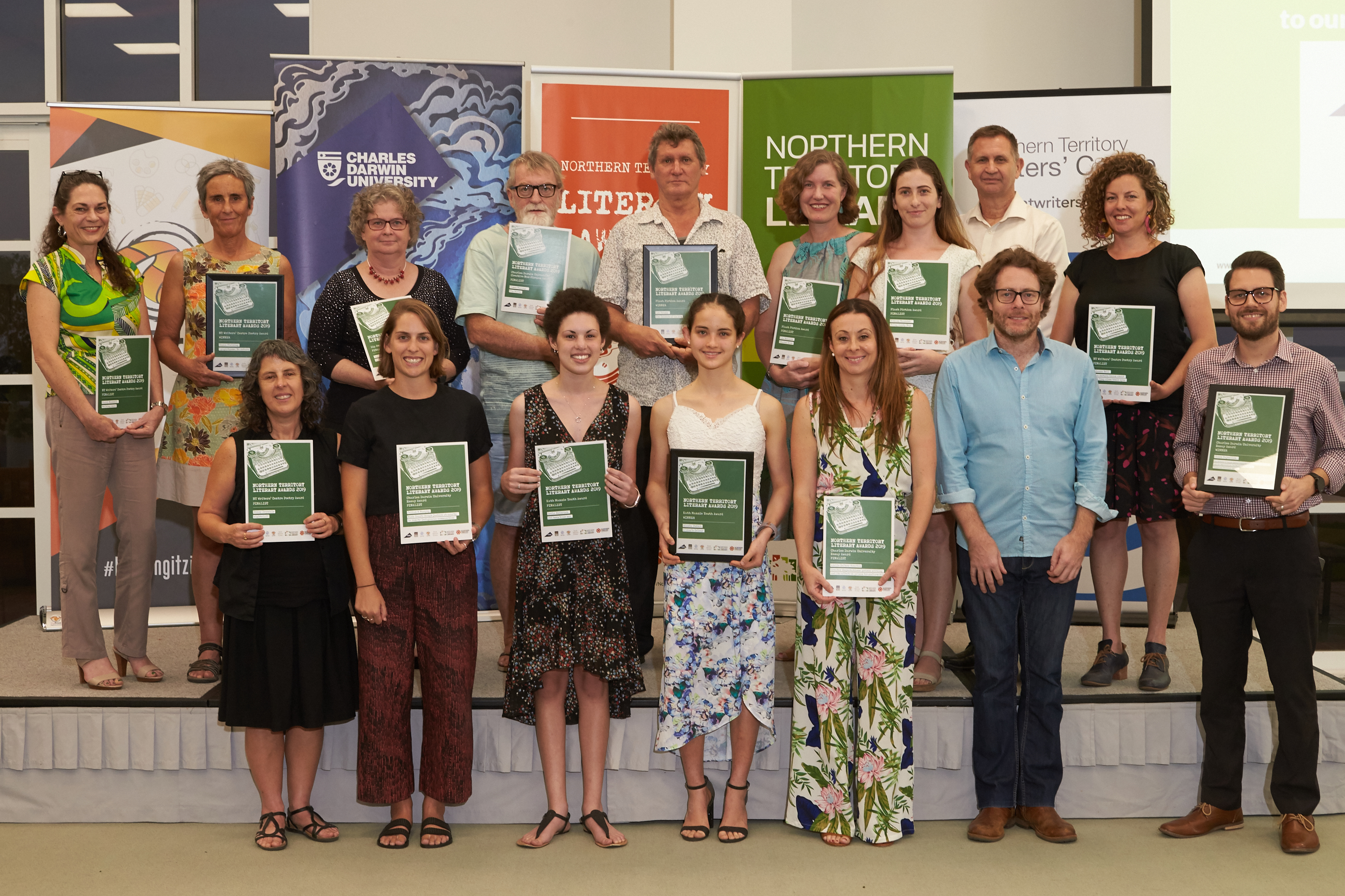 staged photos with two rows of people holding certificates and smiling