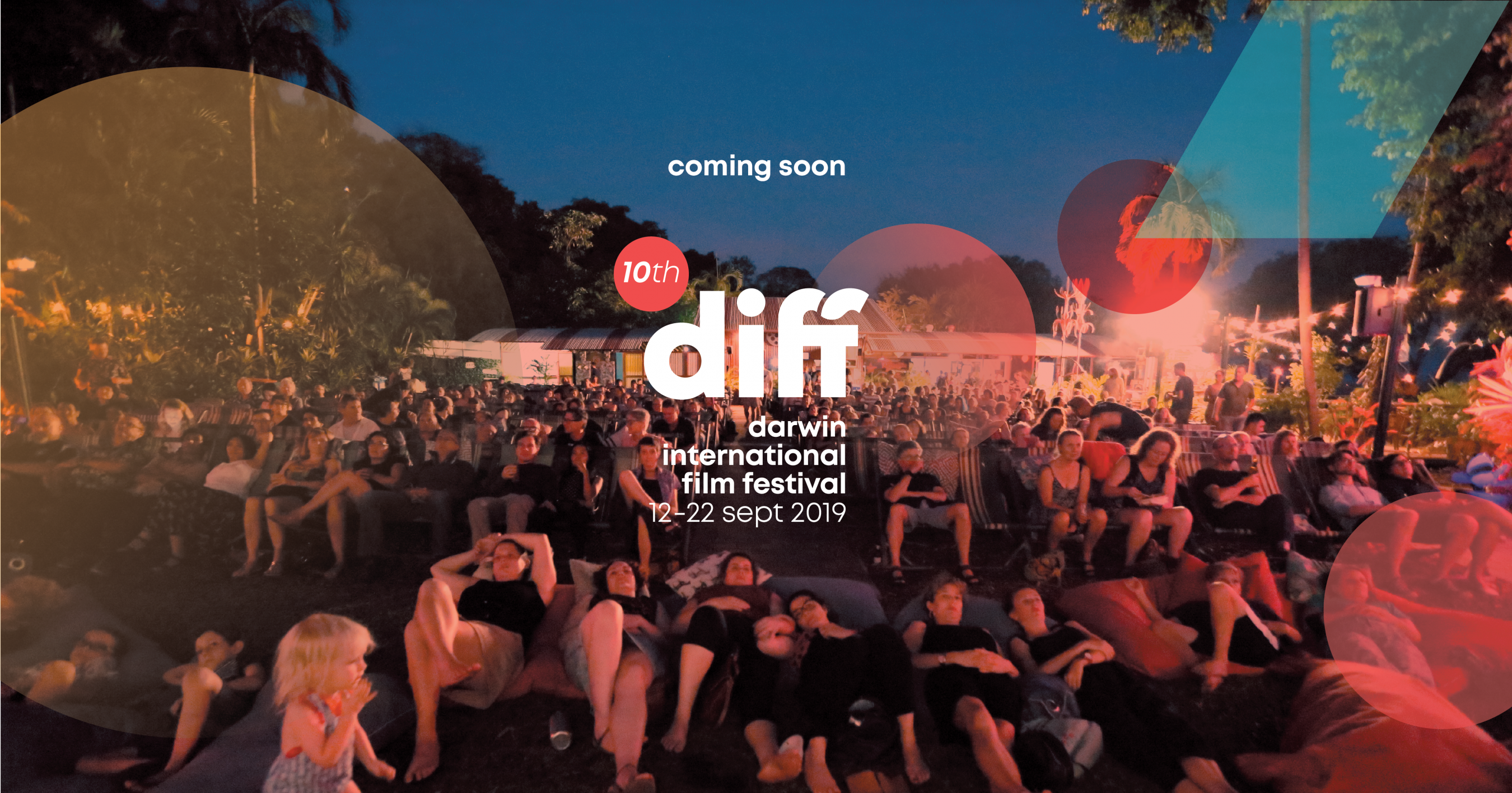 Photo looking back into an audience who are watching a film. IN the foreground people on beanbags, then people on lounge type chairs and then others of straight back chair. Image treated with graphic design of opaque circles and rectangles. Writing in the middle promoting Darwin International Film Festival