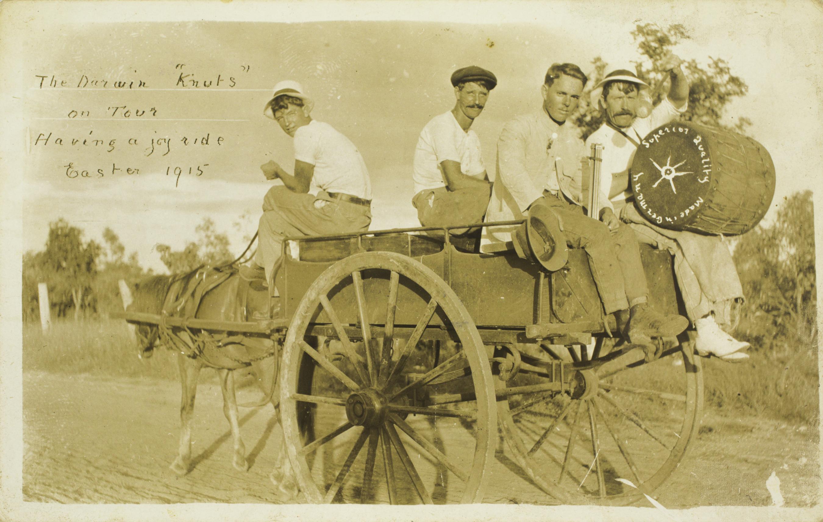 Men riding on a horse drawn carriage.