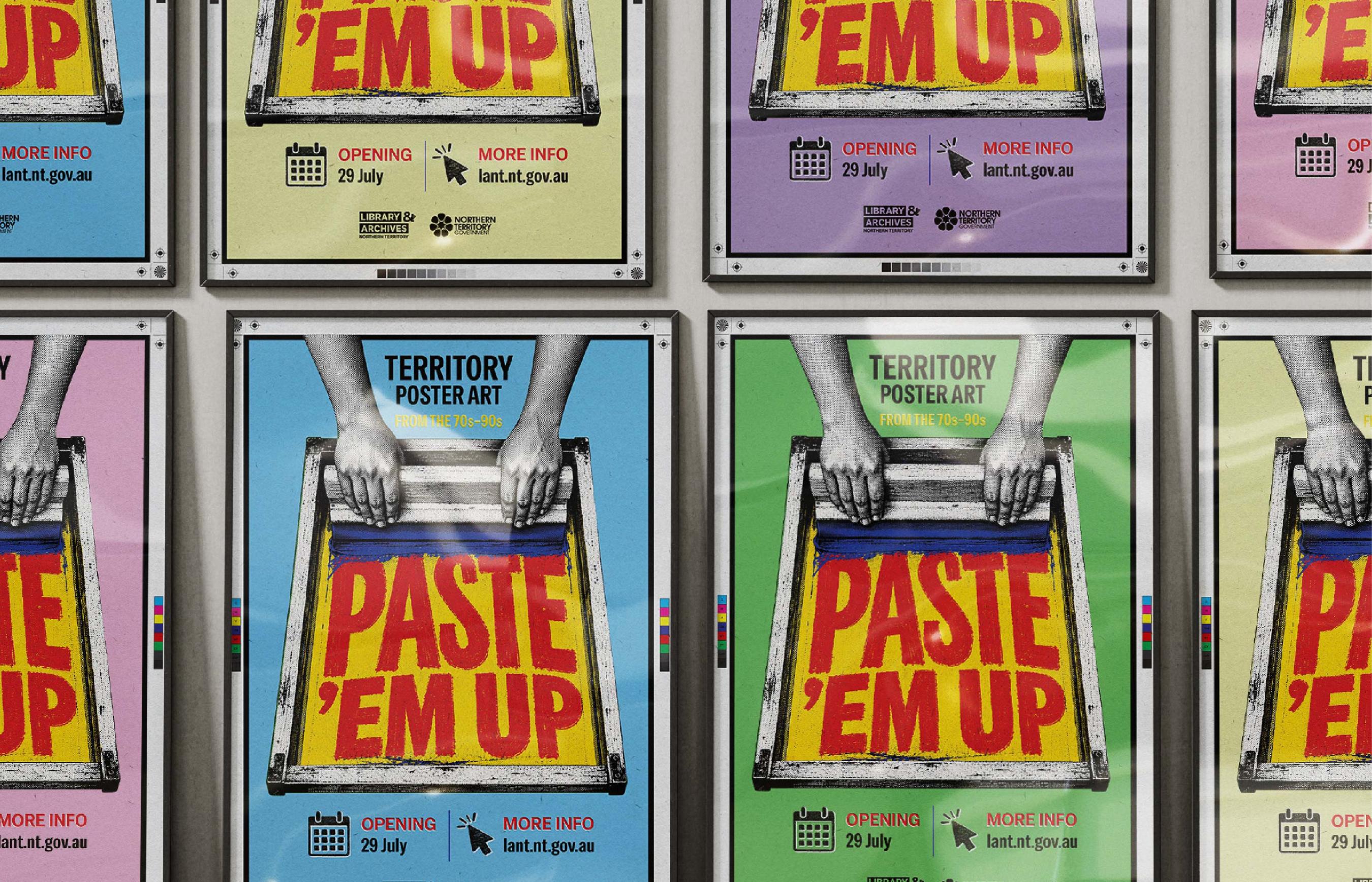Wall covered in different brightly coloured framed 'Paste 'Em Up' posters.