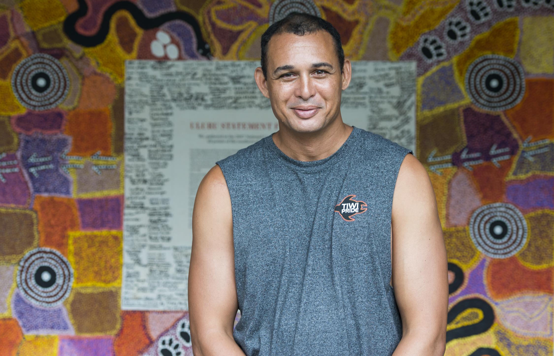 Thomas Mayor in front of the Uluru Statement from the Heart. 