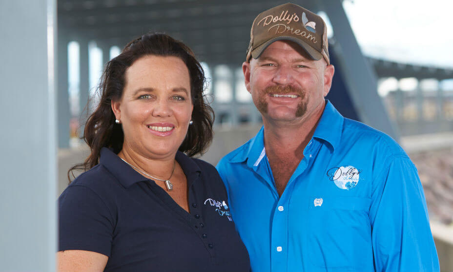 Image of a man and a woman under a bridge smiling