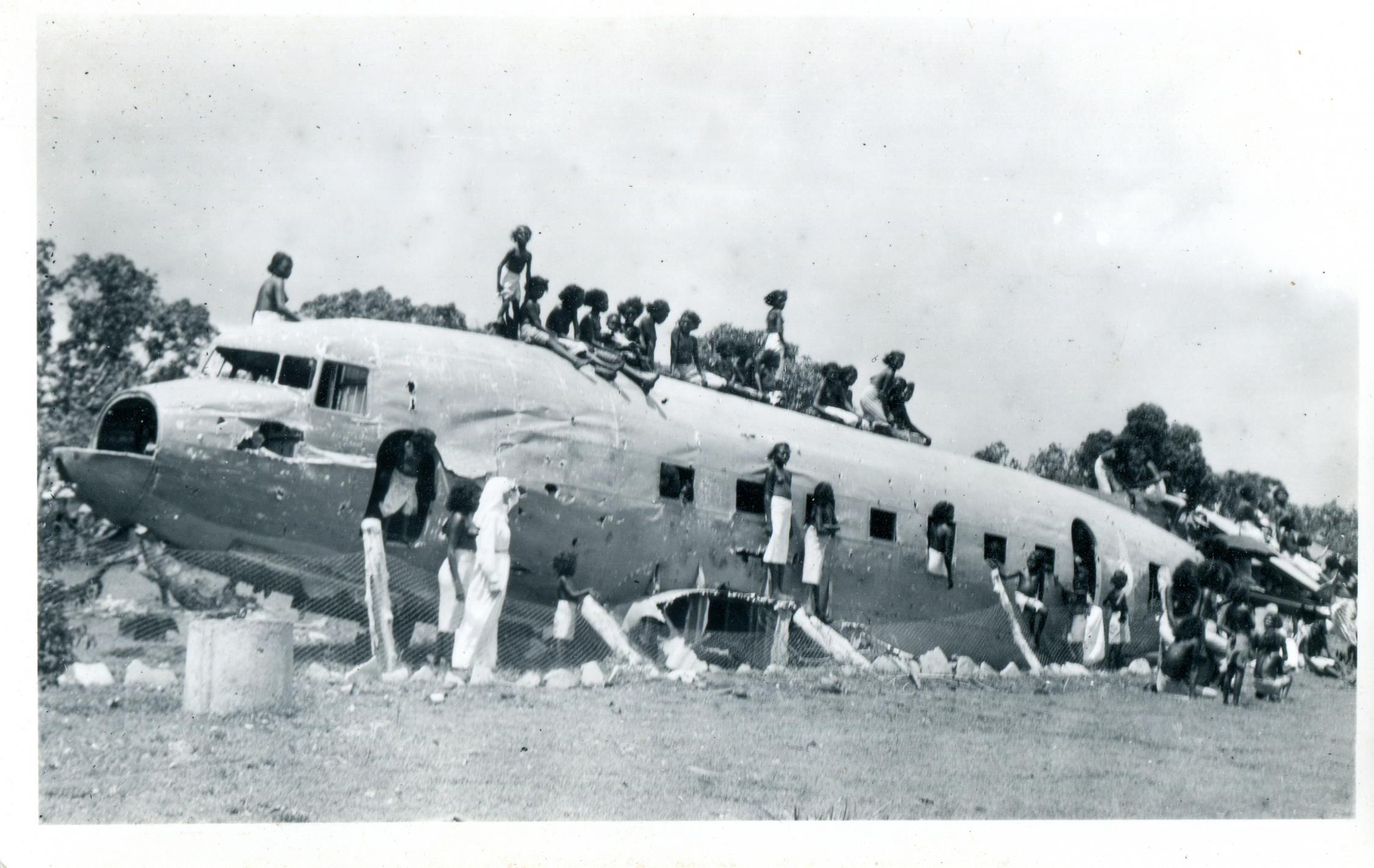 black and white photo of Tiwi Women and lady of the Sacred Heart Sister on DC3 wreckage