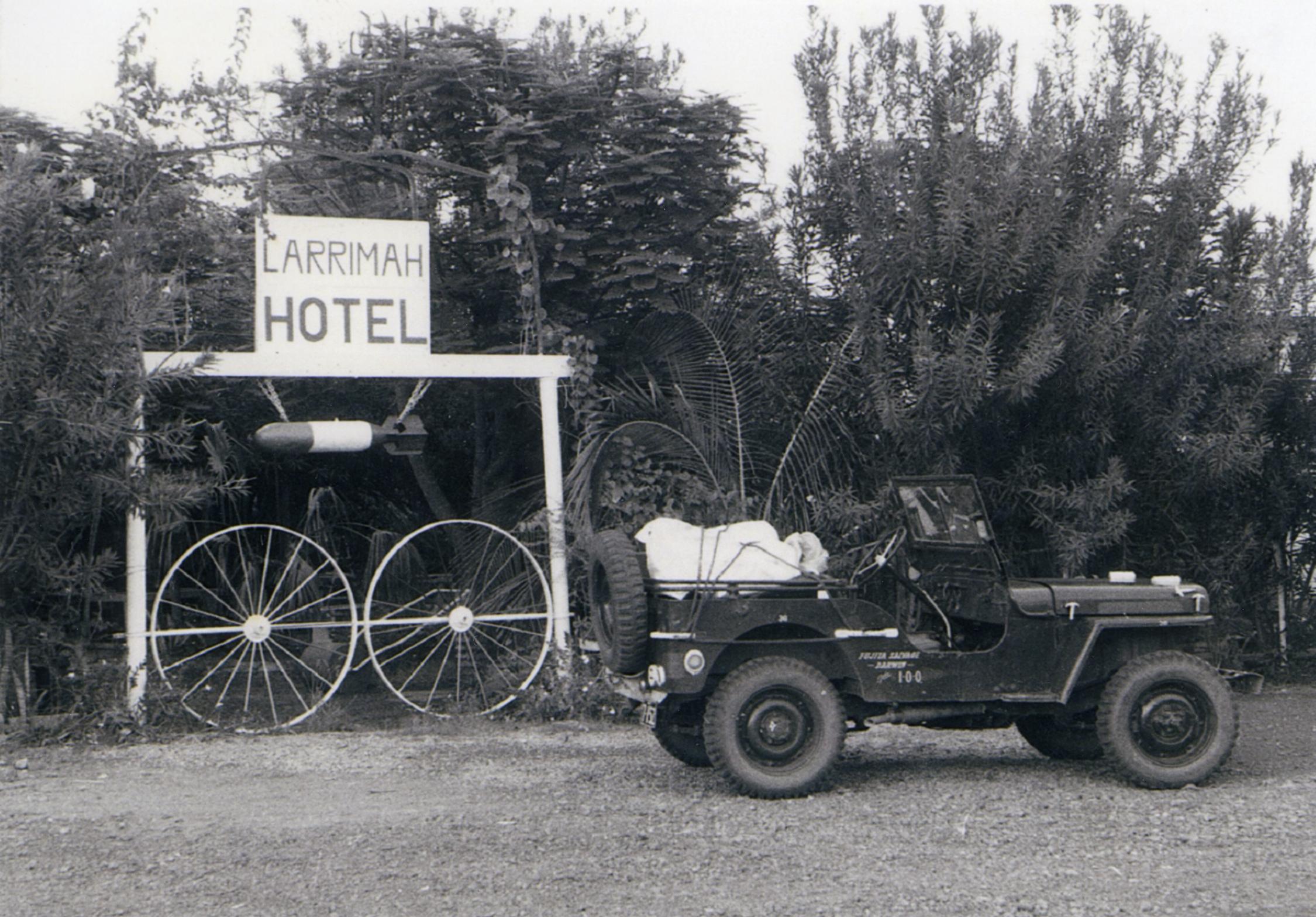 Image of Larrimah Hotel sign with a car in front 