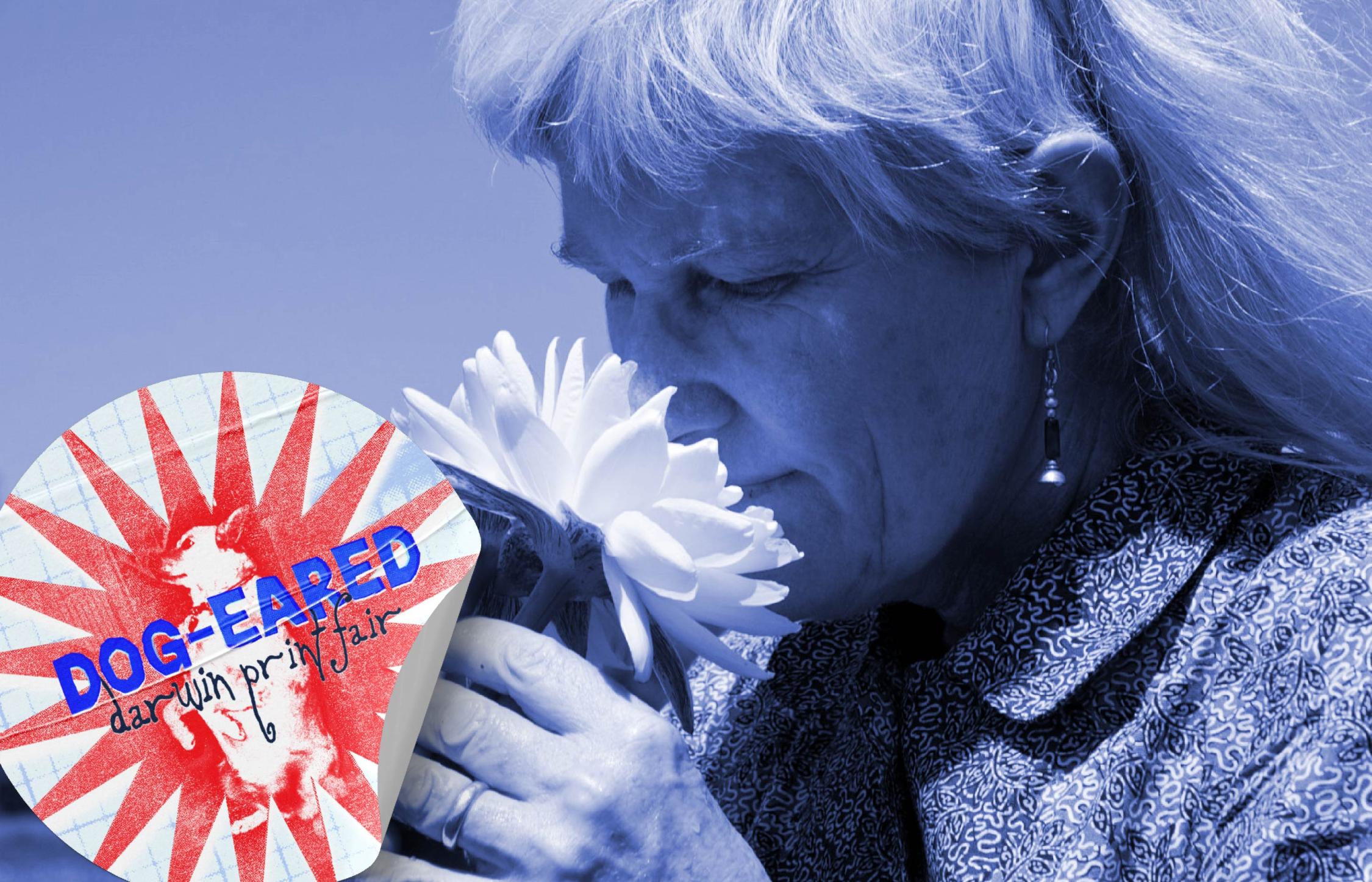 Black and white photograph with blue overlay of woman smelling a flower