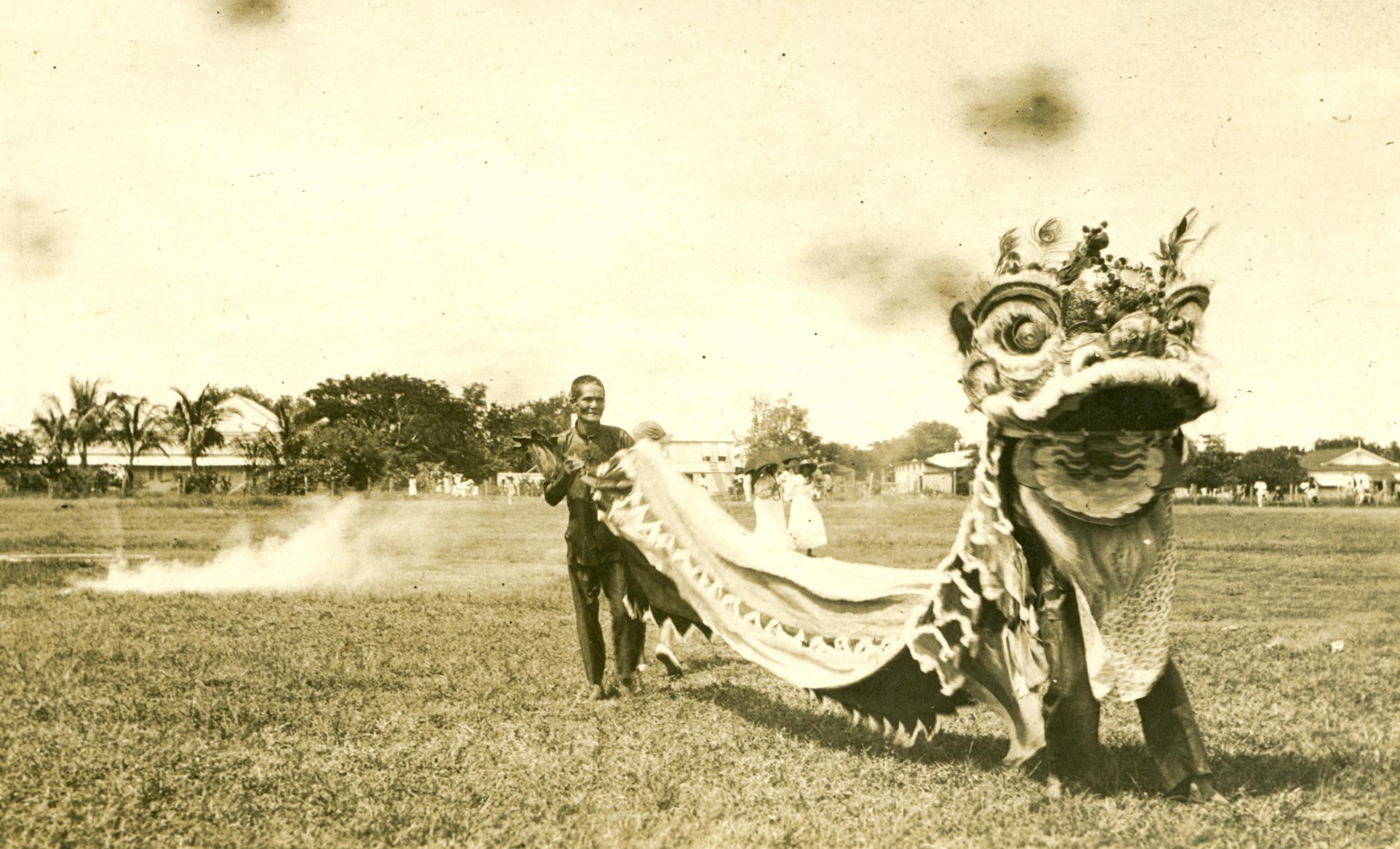 Sepia tone image of lion dancers in 1923.