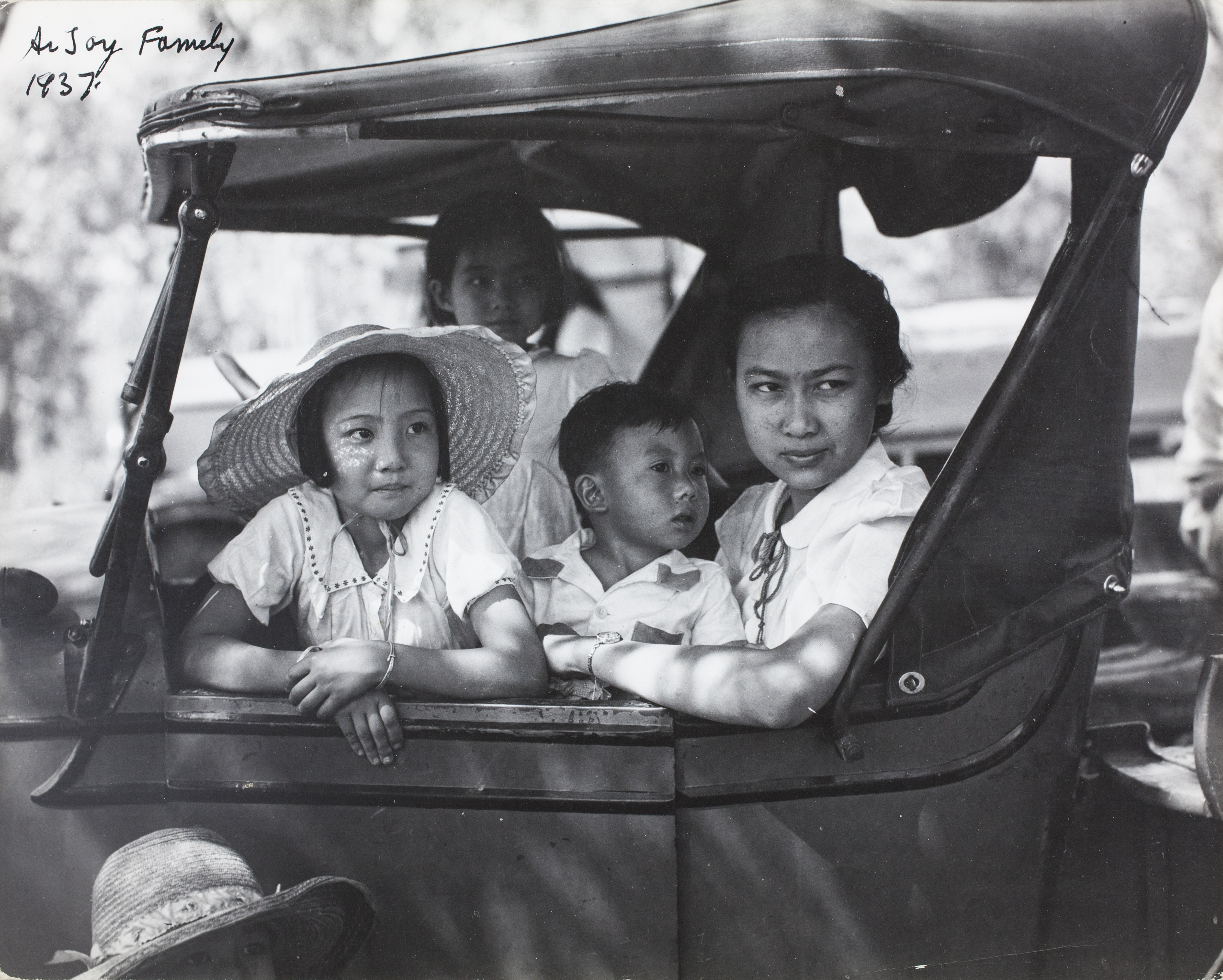 Group of children sitting in a car, looking out