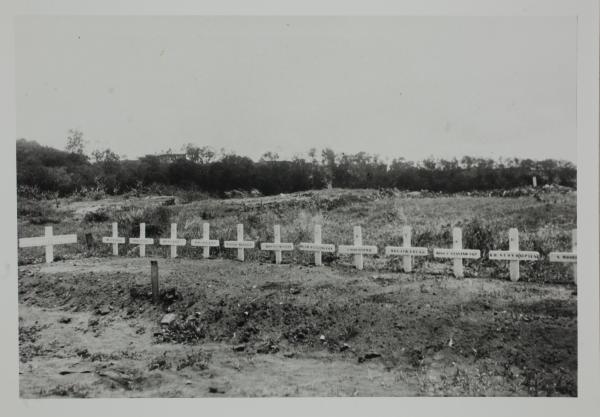 White crosses in a row at the Post master generals staff common grave near near Darwin Hospital, later moved to Berrimah. Now at Adelaide River.