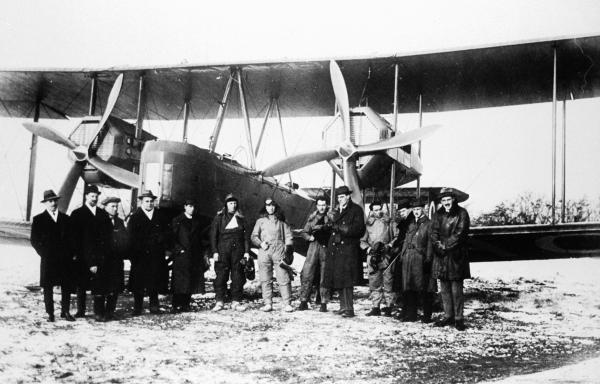 The Smith Brothers, Bennett and Shiers stand beside their Vickers Vimy aircraft before take-off at Hounslow Heath in 1919.