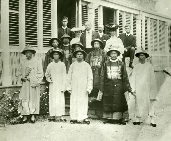 Several people standing in front of a house
