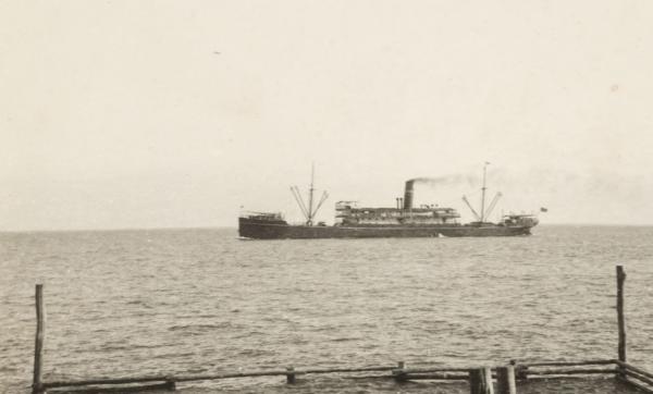 Photograph of SS Mataram at sea with small post and rail sea baths in the foreground.
